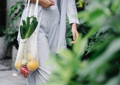 woman with a bag full of vegetables